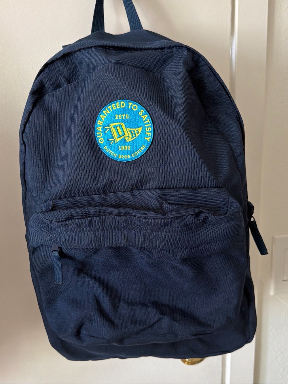Dutch Bros Navy Backpack with Teal and Yellow Patch